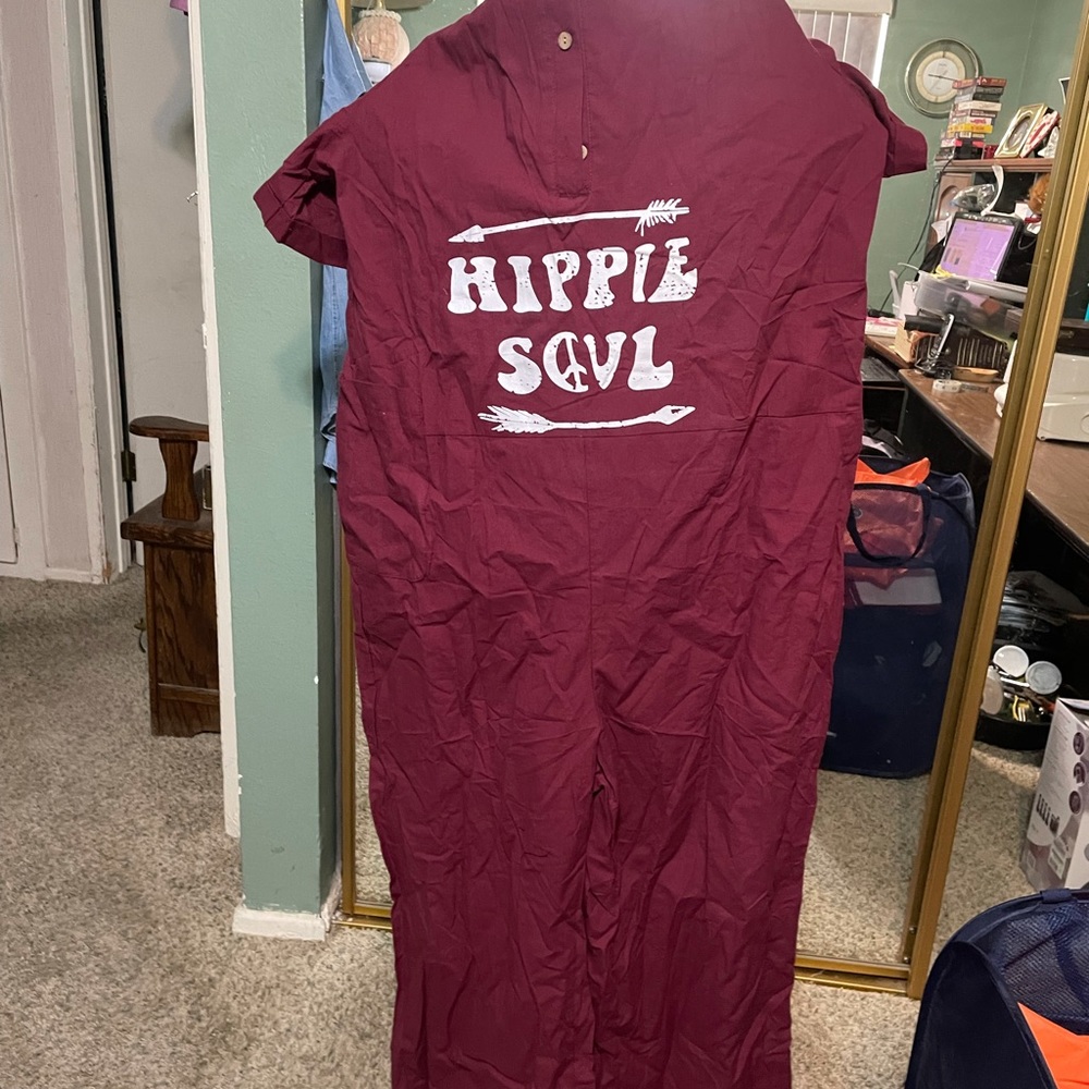 This one pc jump suit is red A zipper in back three buttons in front. Cotton